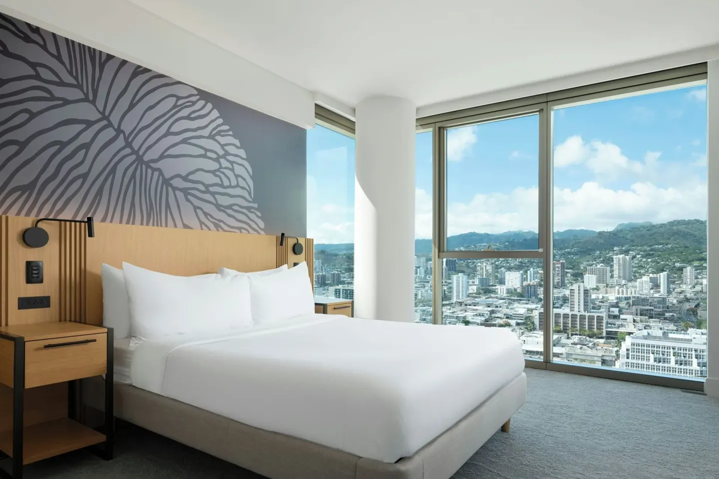 Mountain View one-bedroom suite king bed with city and mountain windows at Renaissance Honolulu Hotel & Spa.