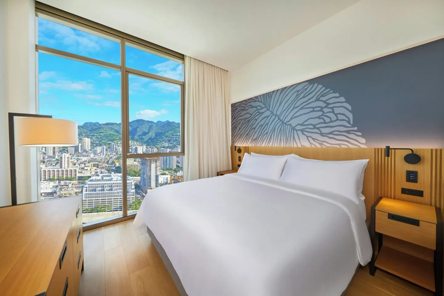 King bedroom with mountain-view windows at Renaissance Honolulu Hotel & Spa.
