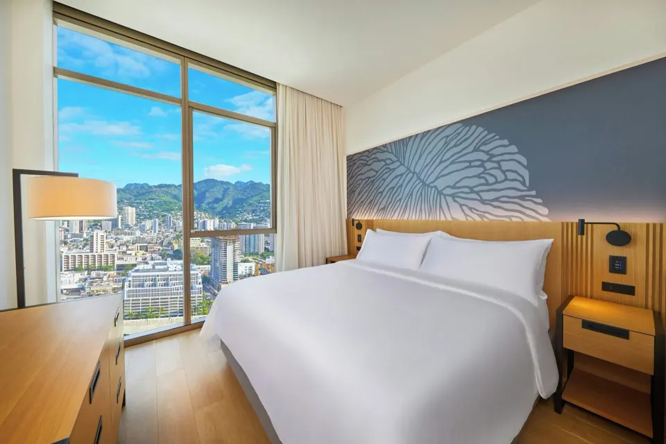 King bedroom with mountain-view windows at Renaissance Honolulu Hotel & Spa.