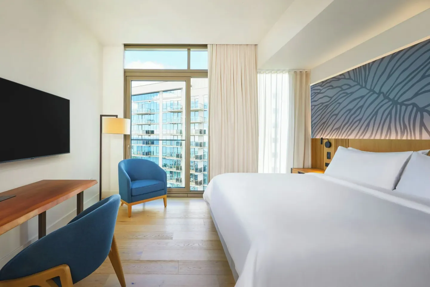 King bedroom in an Ocean View one-bedroom suite at Renaissance Honolulu Hotel & Spa with window seating.