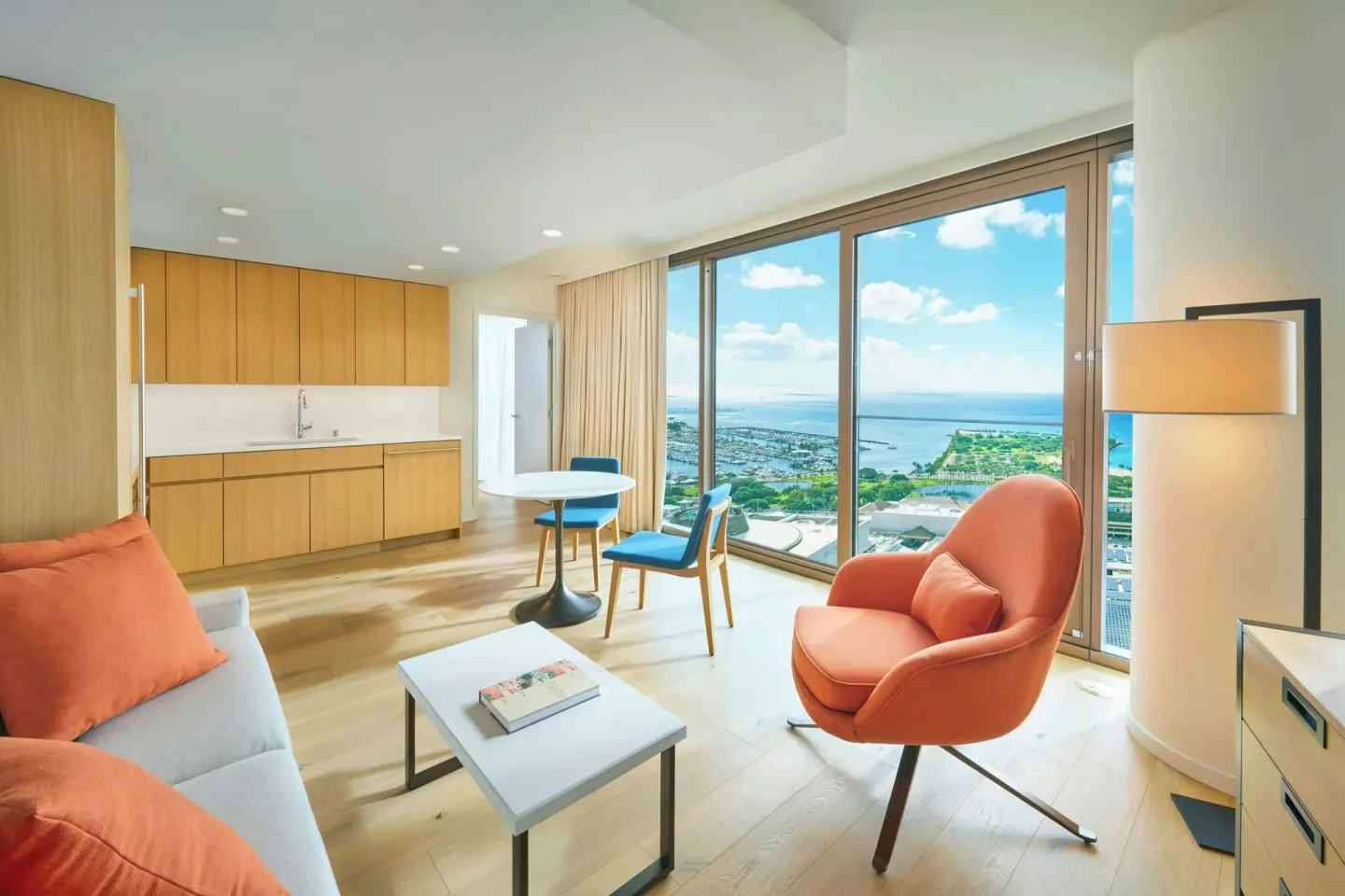 Ocean View one-bedroom suite at Renaissance Honolulu Hotel & Spa with kitchen, lounge seating, and ocean view.