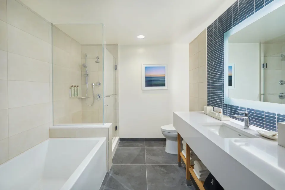 Ocean View Room bathroom with tub, shower, vanity, and mirror at Renaissance Honolulu Hotel & Spa.