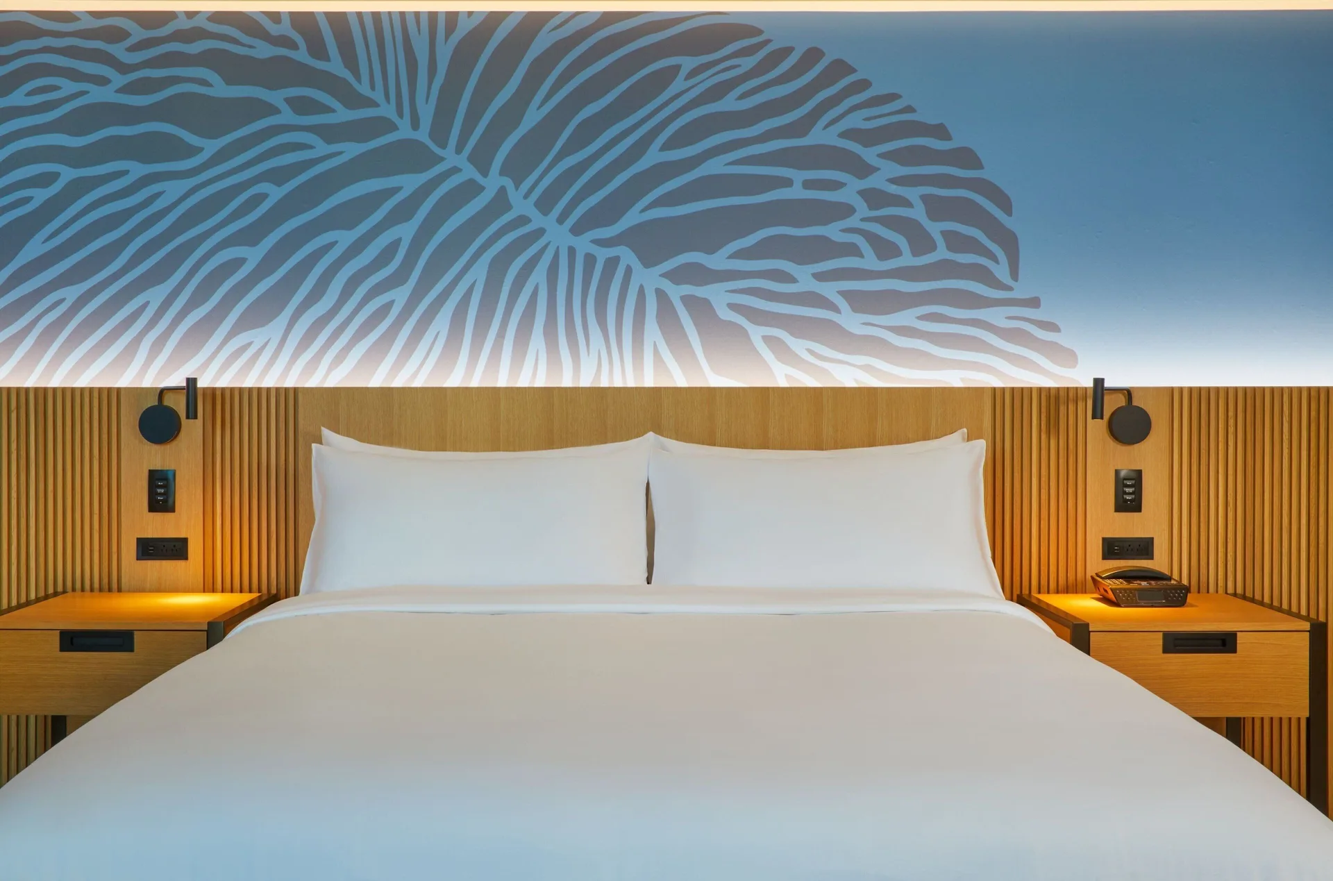 Ocean View Room king bed with blue wall art at Renaissance Honolulu Hotel & Spa.
