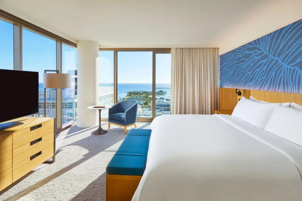 Ocean View Room with king bed, seating, TV, and ocean-facing windows at Renaissance Honolulu Hotel & Spa.