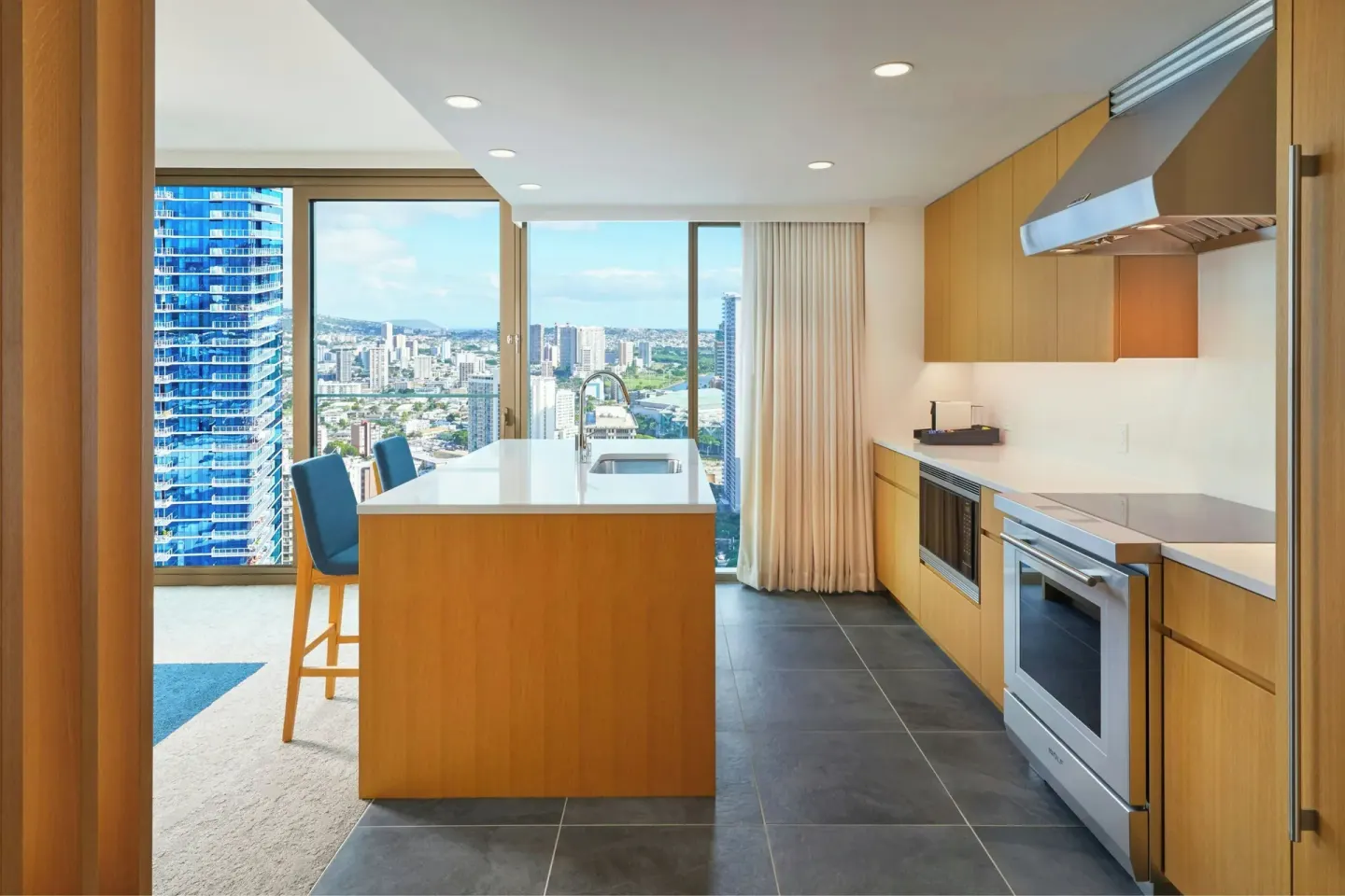Suite kitchen with island and city views at Renaissance Honolulu Hotel & Spa.
