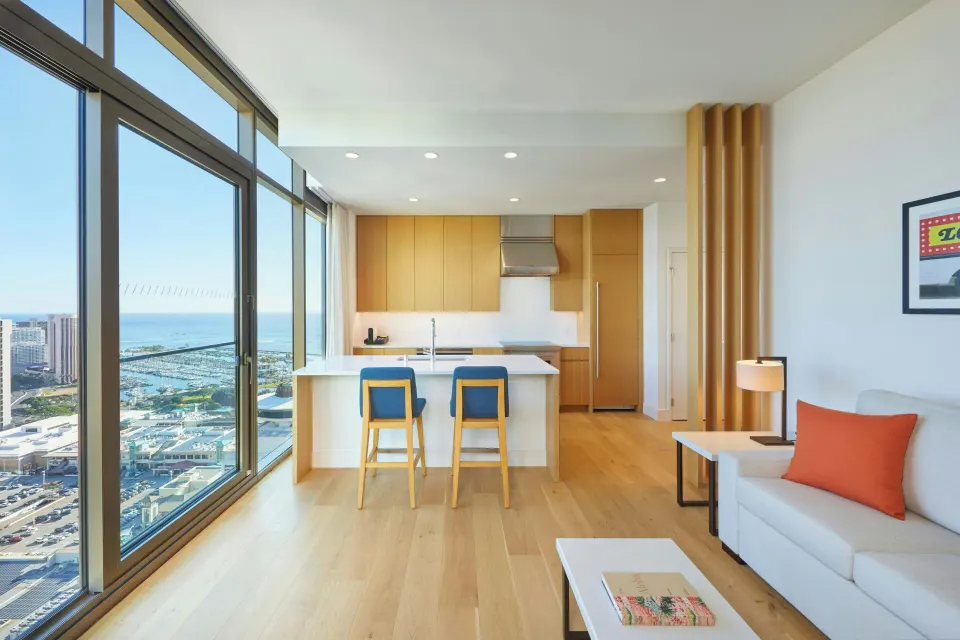 Residential suite living area with kitchen and ocean view at Renaissance Honolulu Hotel & Spa.
