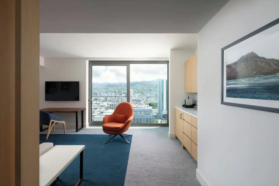 Panoramic View 1 Bedroom Suite living area at Renaissance Honolulu Hotel & Spa with mountain city view.