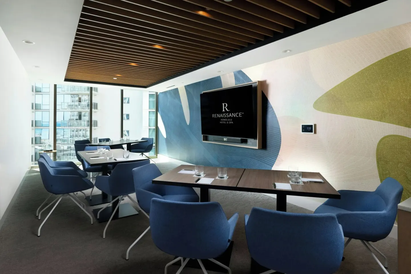Small meeting room with blue chairs and display at Renaissance Honolulu Hotel & Spa.