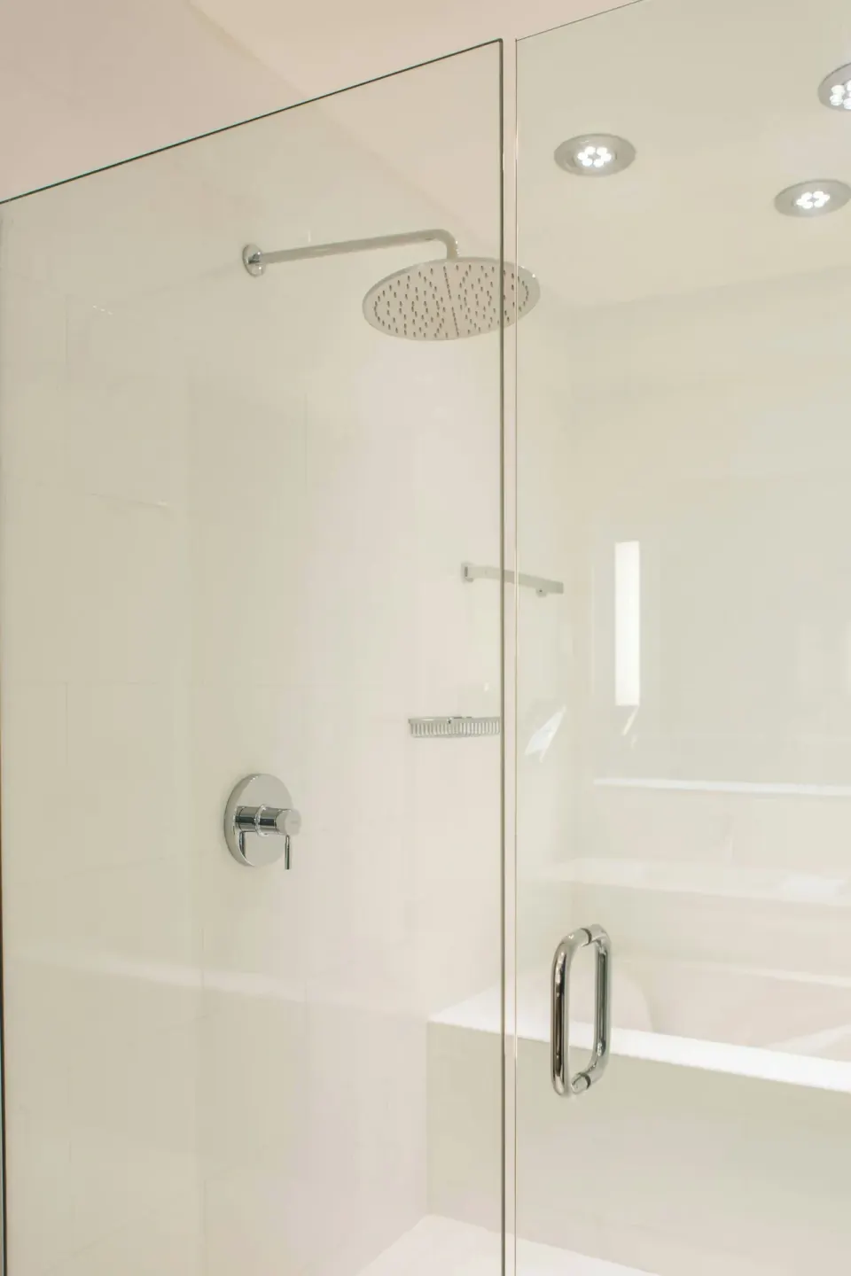 Glass-enclosed shower and bathtub in a bathroom at Renaissance Wind Creek Aruba Resort.
