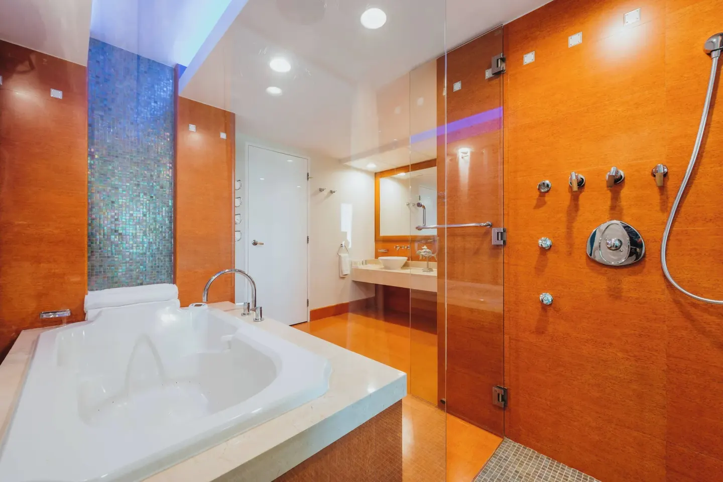 Modern bathroom with jetted tub and glass shower at Renaissance Wind Creek Aruba Resort.