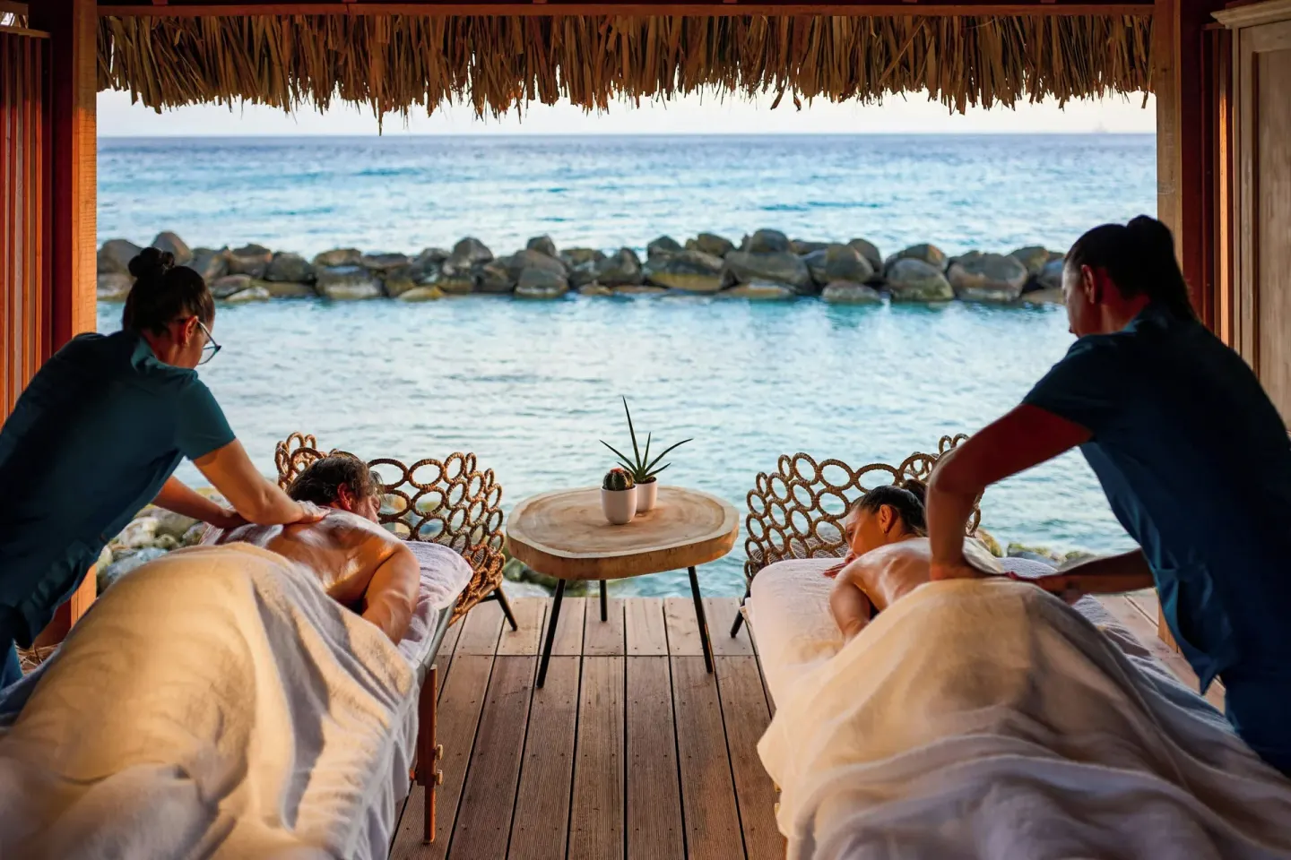 Oceanfront couples massage setup at Renaissance Wind Creek Aruba Resort.