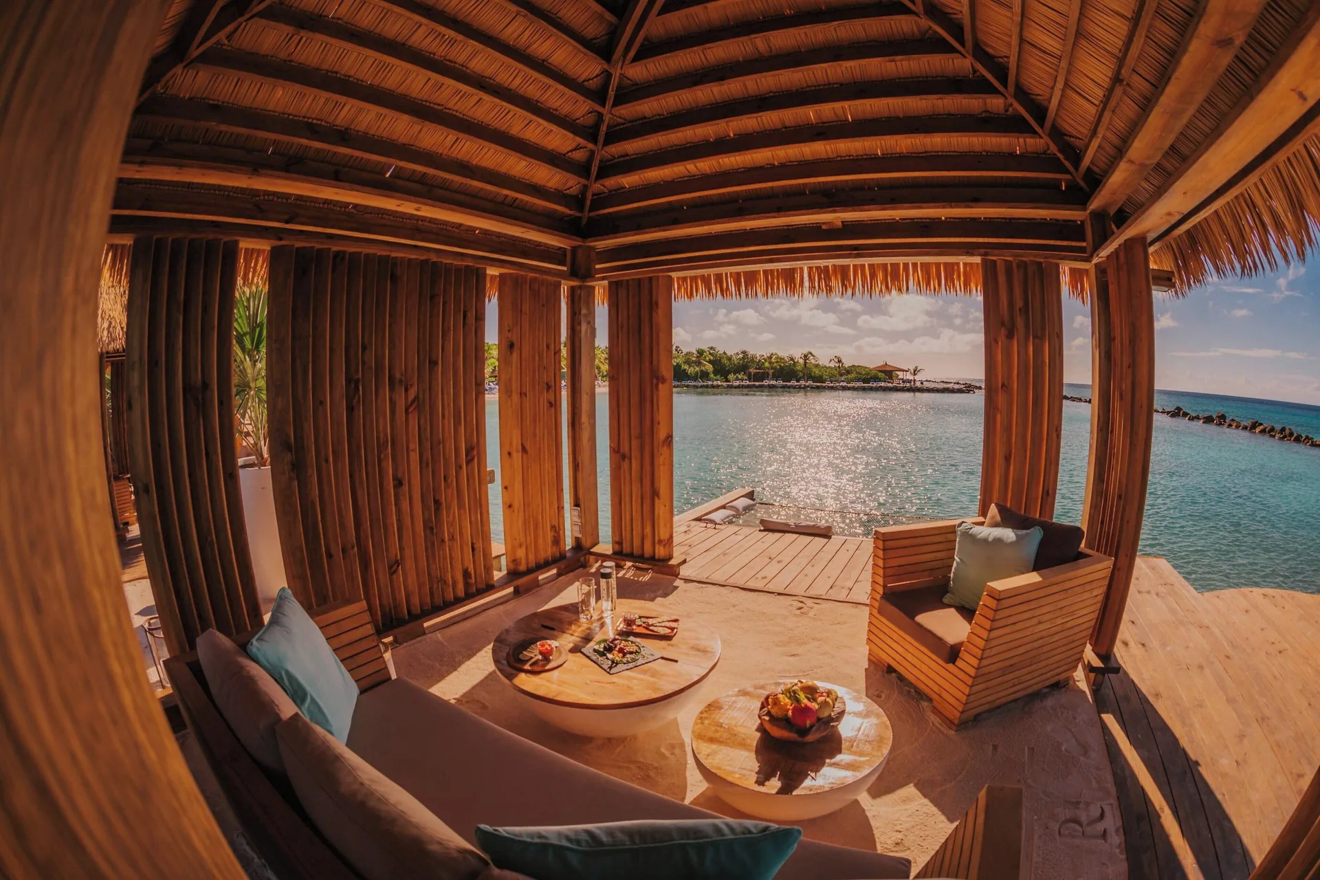 An open-air cabana lounge overlooks the water at Renaissance Wind Creek Aruba Resort.