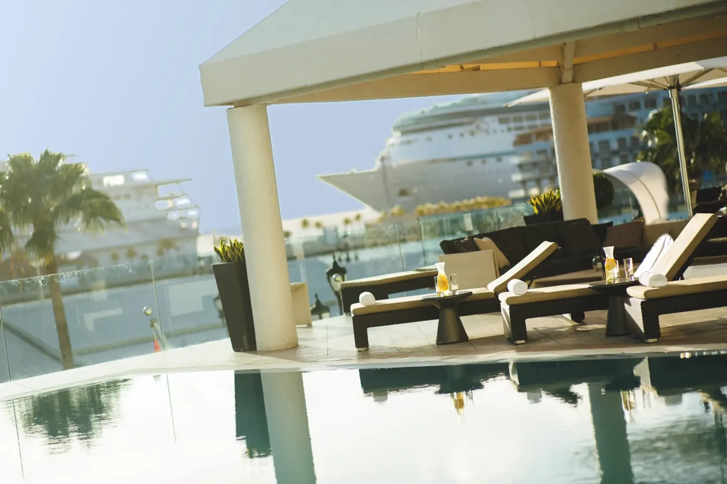 Poolside lounge chairs with harbor views at Renaissance Wind Creek Aruba Resort.