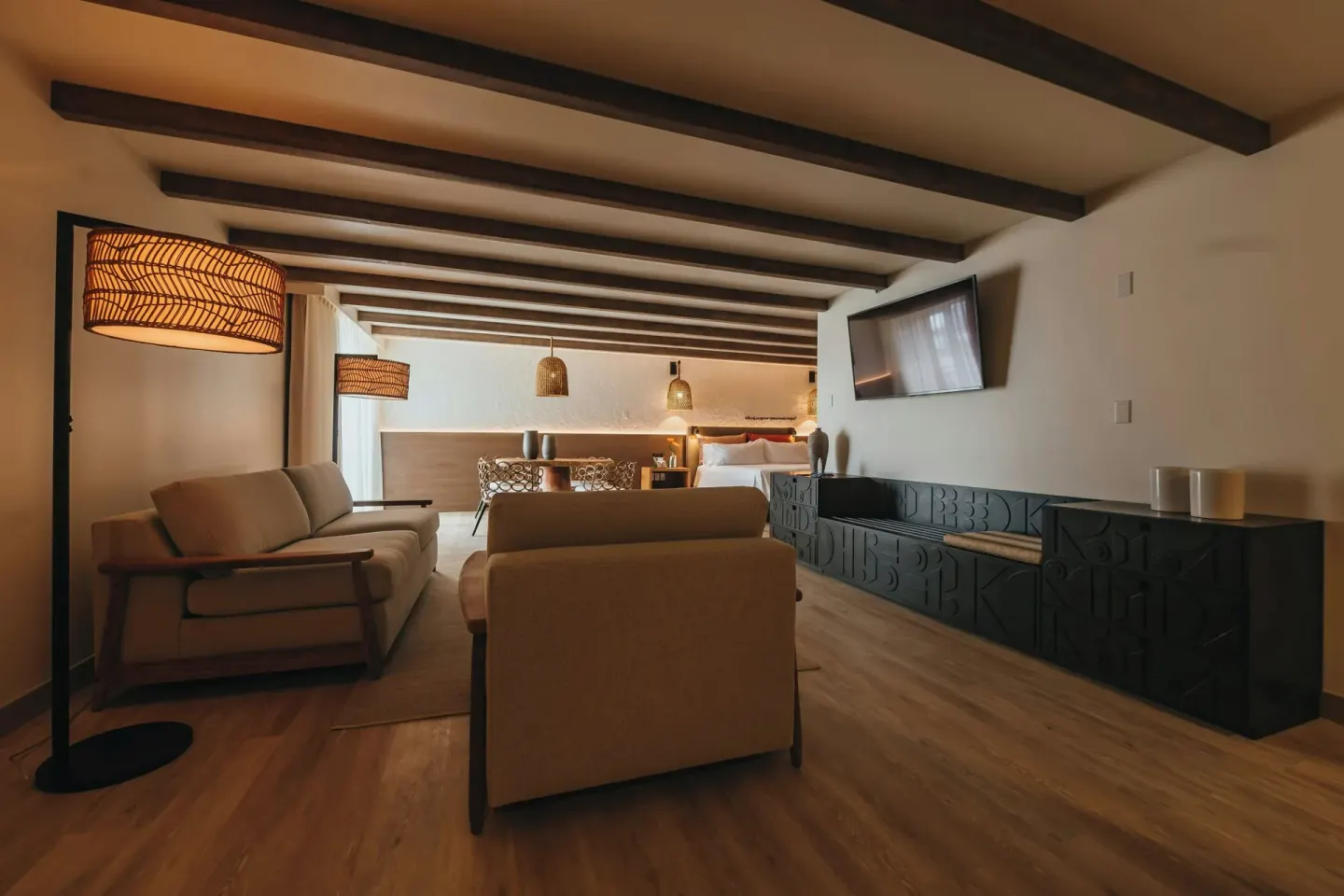 Spacious suite with lounge seating and a bed at Renaissance Wind Creek Aruba Resort.