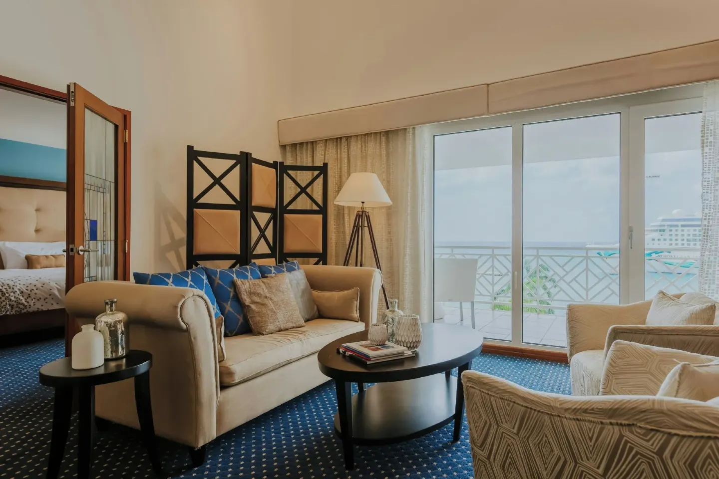 Suite sitting area with balcony doors at Renaissance Wind Creek Aruba Resort.