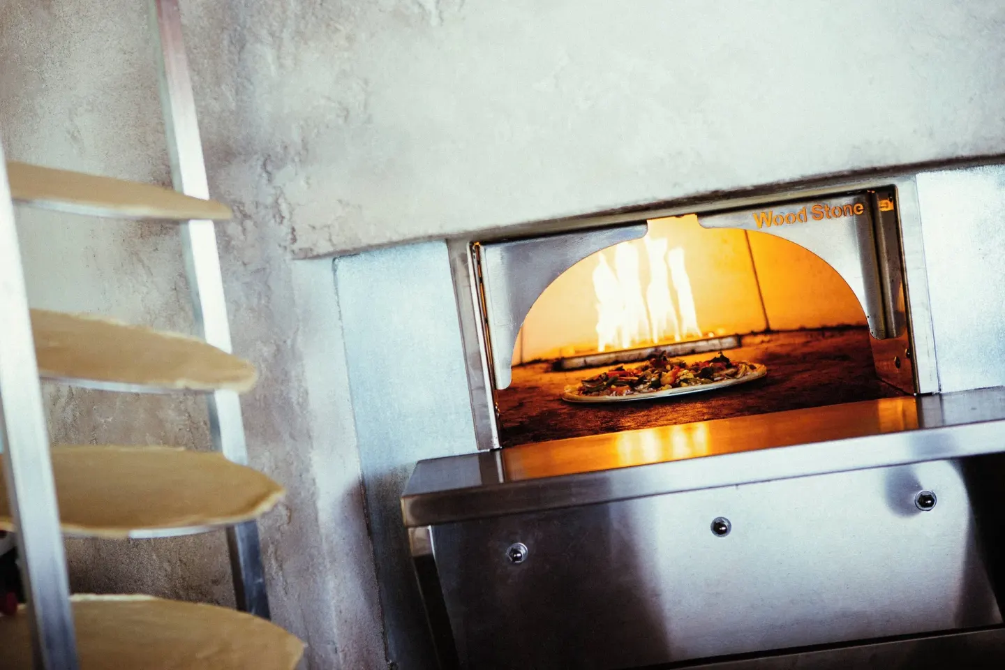 Pizza baking in a wood-fired oven at Renaissance Wind Creek Aruba Resort.