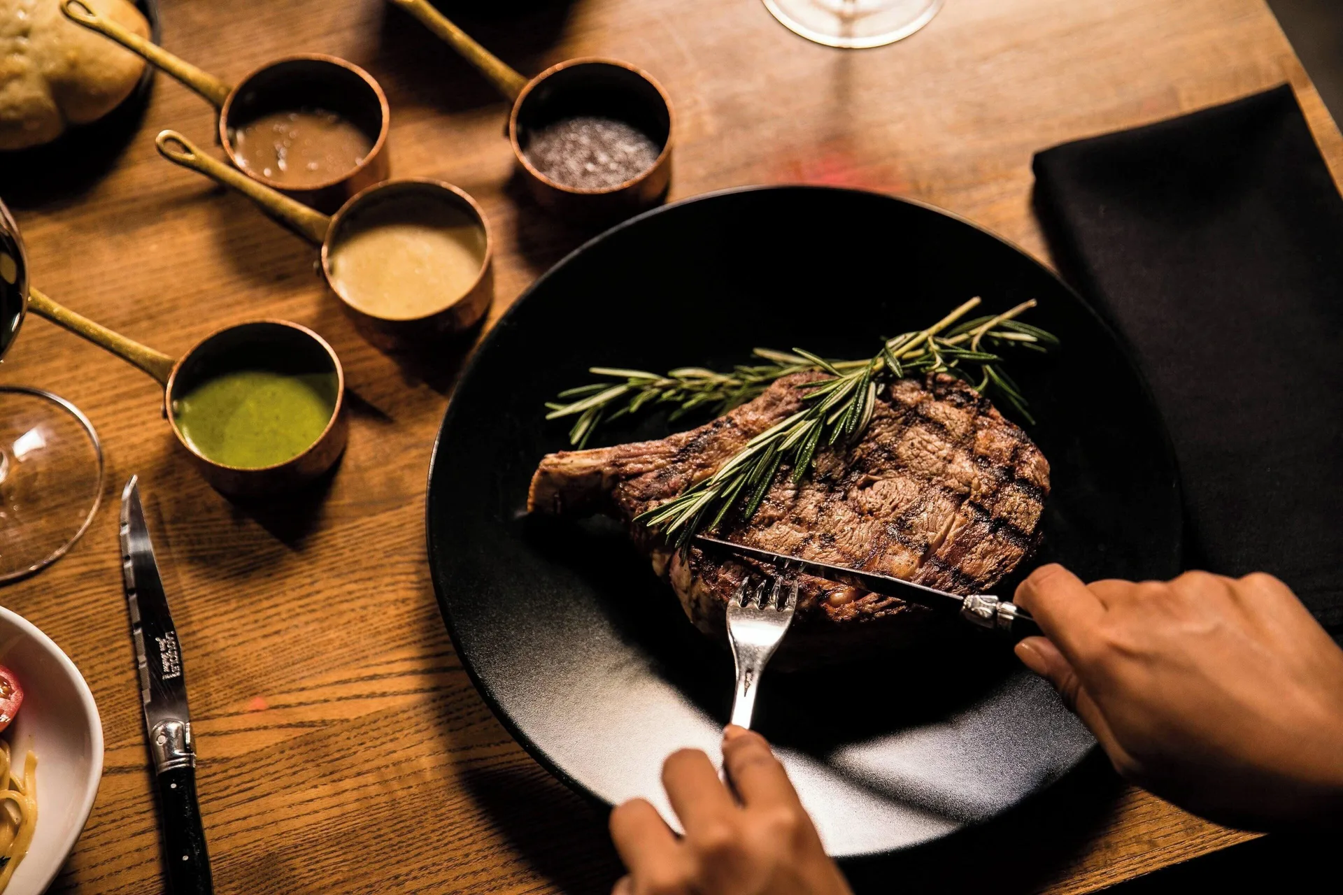 Grilled steak on a black plate at Renaissance Wind Creek Aruba Resort.