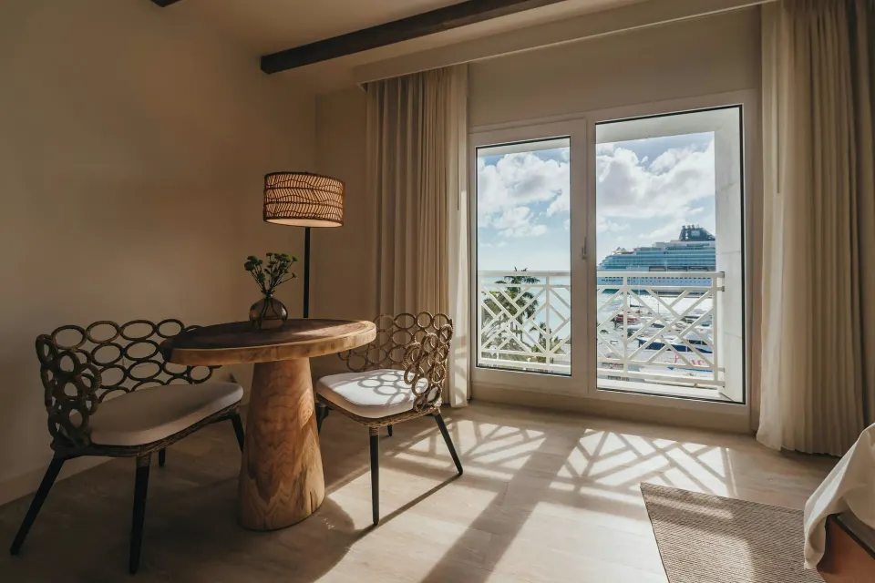 Executive Suite dining nook and balcony doors at Renaissance Wind Creek Aruba Resort.