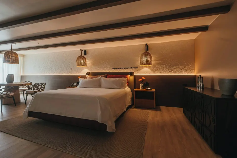 Executive Suite king bed and dining area at Renaissance Wind Creek Aruba Resort.