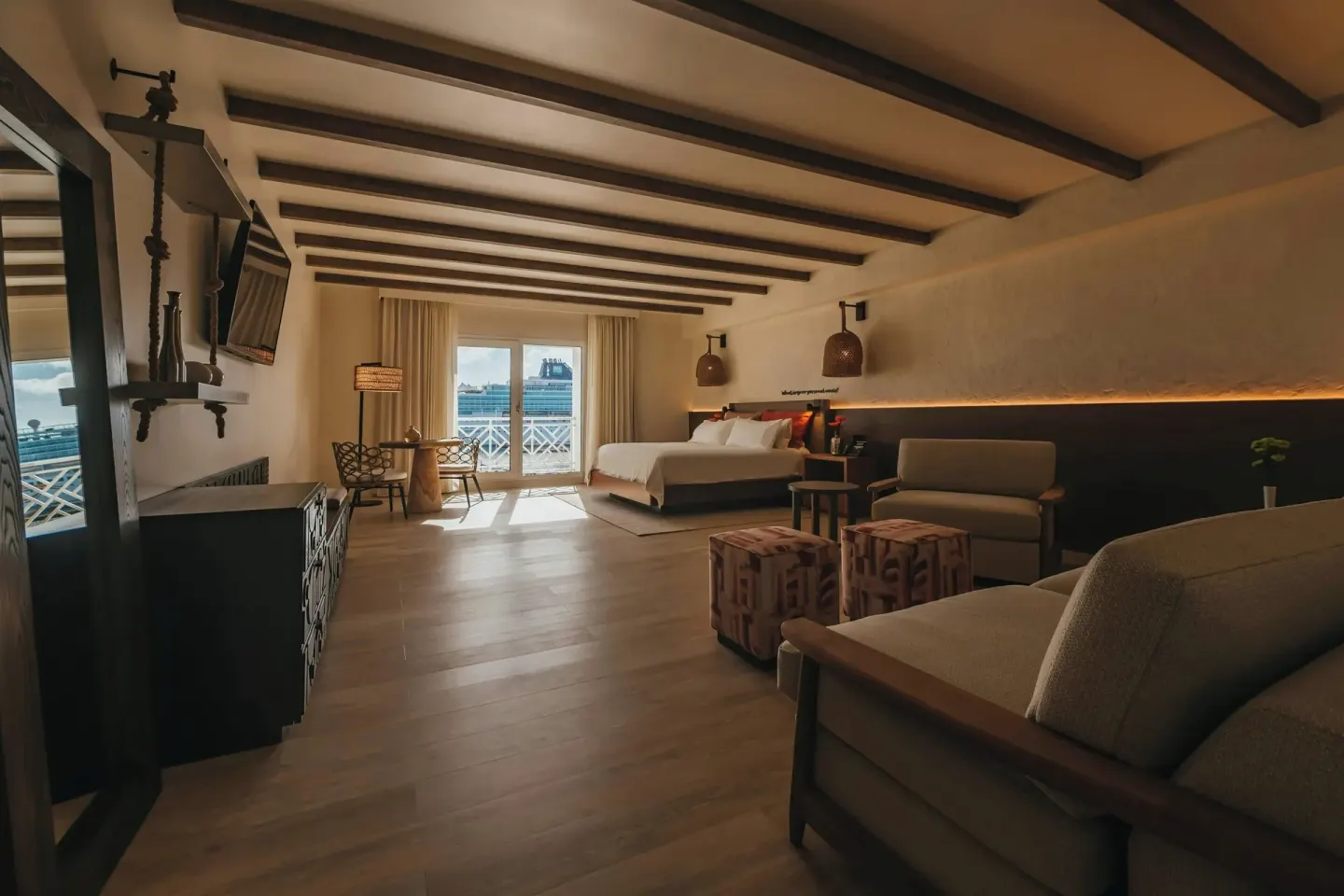 Executive Suite seating area and king bed at Renaissance Wind Creek Aruba Resort.