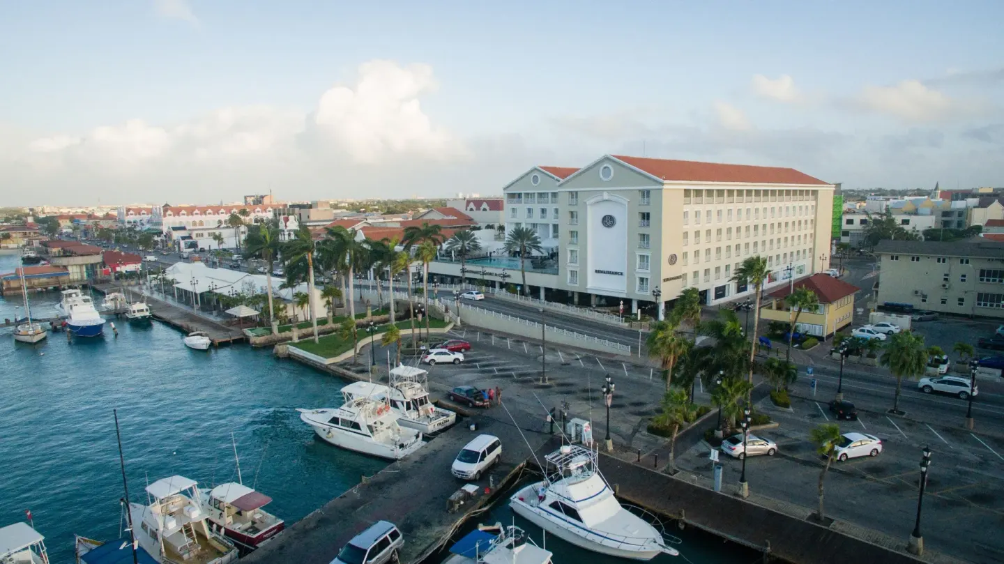 Island view from the marina hotel with boats and waterfront at Renaissance Wind Creek Aruba Resort.