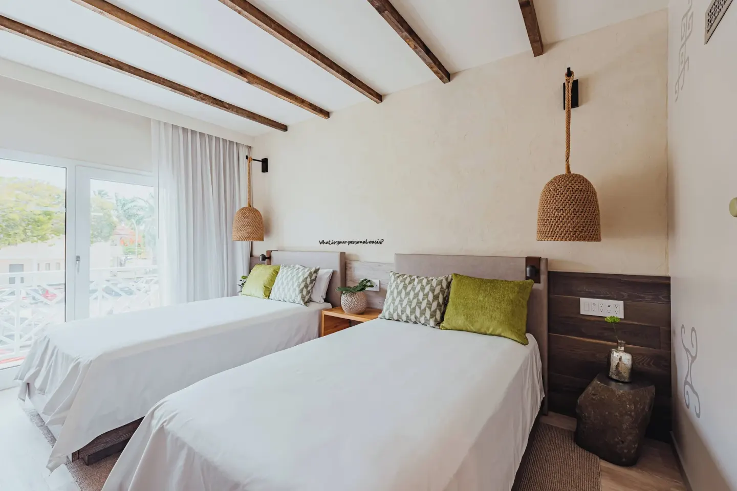 Two-bed island view guest room with balcony doors at Renaissance Wind Creek Aruba Resort.