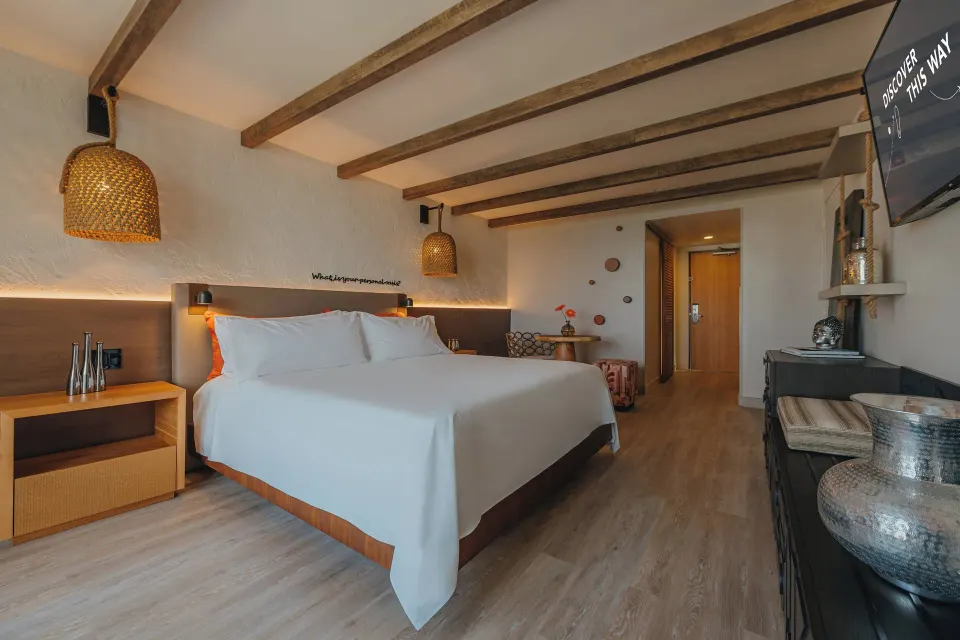Ocean View room with king bed, dresser, and entry area at Renaissance Wind Creek Aruba Resort.