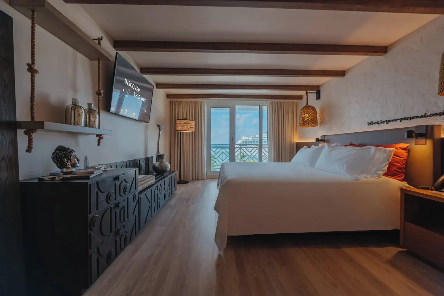 King bed and balcony view in an Ocean View room at Renaissance Wind Creek Aruba Resort.
