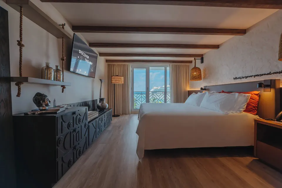 King bed and balcony view in an Ocean View room at Renaissance Wind Creek Aruba Resort.