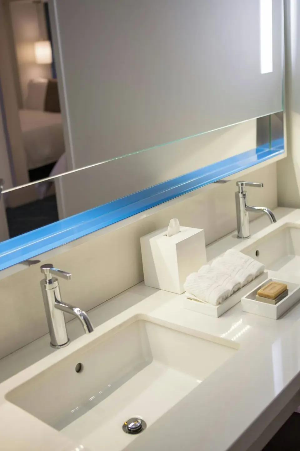 Double-sink bathroom vanity with mirror in a suite at Renaissance Wind Creek Aruba Resort.
