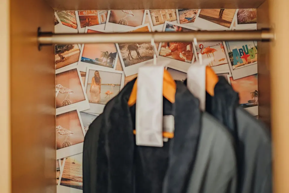 Closet with hanging robes in a suite at Renaissance Wind Creek Aruba Resort.