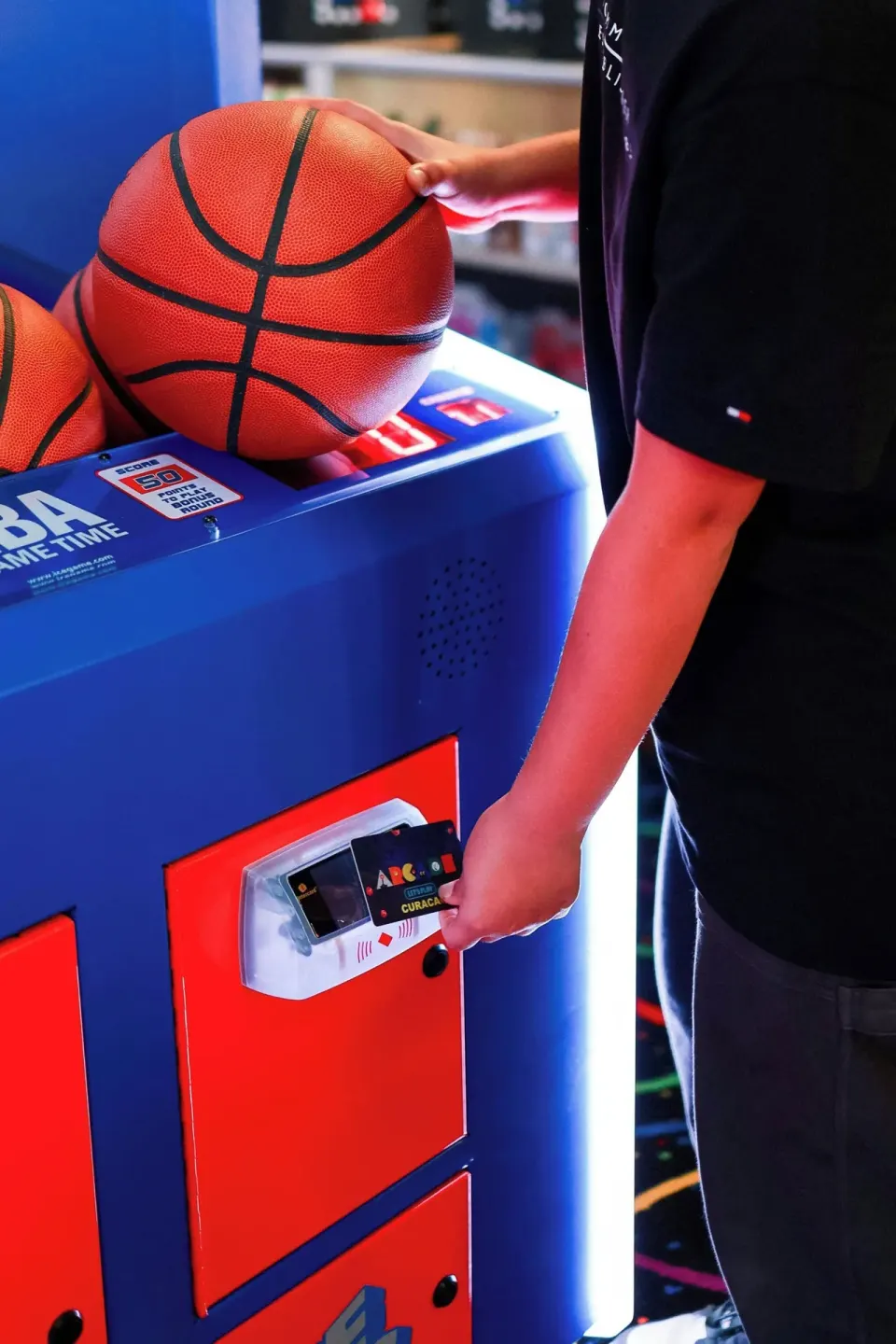 Basketballs and a card reader at the arcade in Renaissance Wind Creek Curacao Resort.