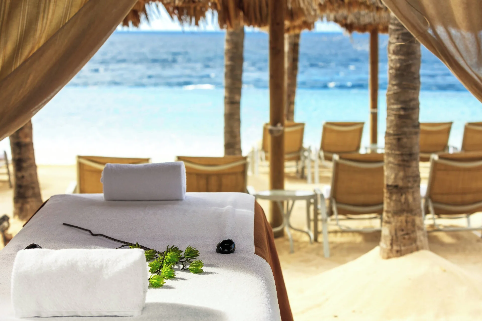 Massage table facing the beach at Renaissance Wind Creek Curacao Resort.