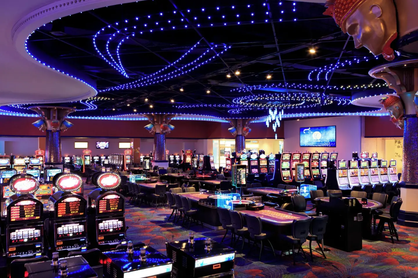 Wide casino floor with slot machines and gaming tables at Renaissance Wind Creek Curacao Resort.