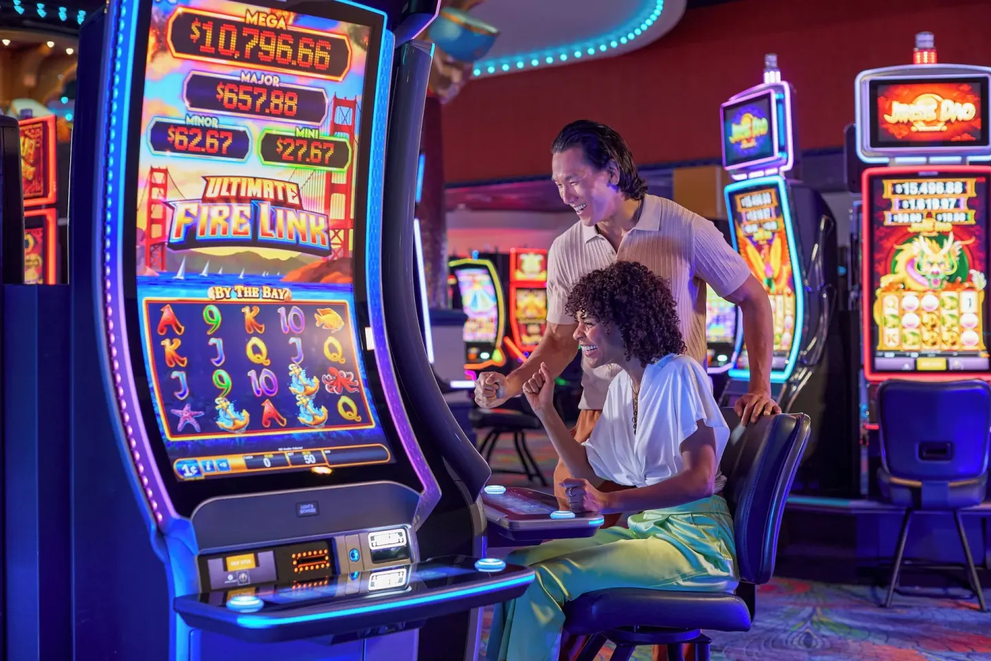 Guests playing a slot machine in the casino at Renaissance Wind Creek Curacao Resort.