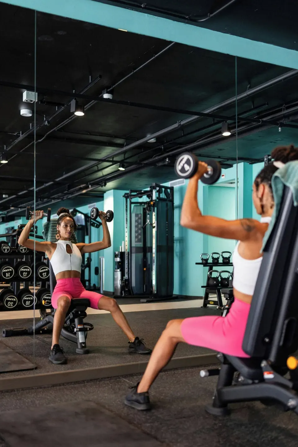 Guest lifting dumbbells in the gym at Renaissance Wind Creek Curacao Resort.