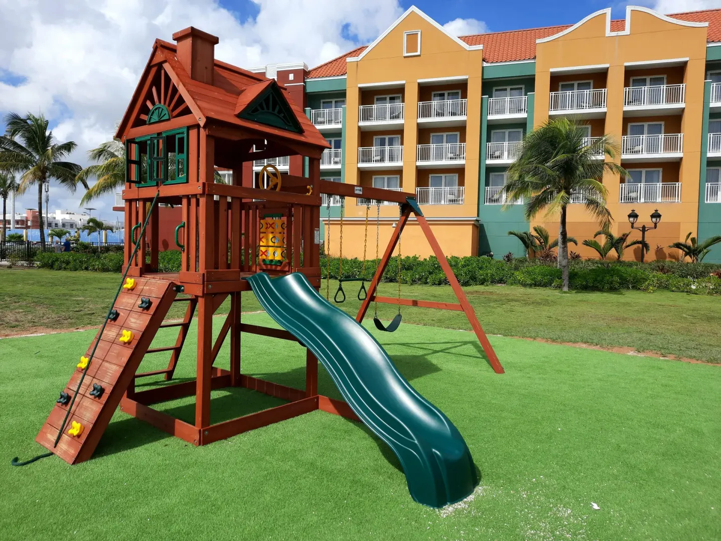 Outdoor playground with slide and swings at Renaissance Wind Creek Curacao Resort.