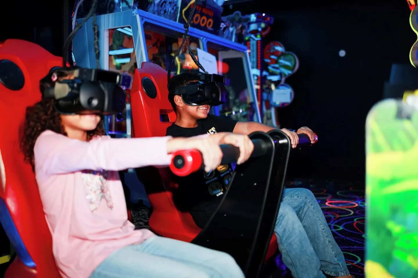 Two children use a virtual reality arcade ride at Renaissance Wind Creek Curacao Resort.
