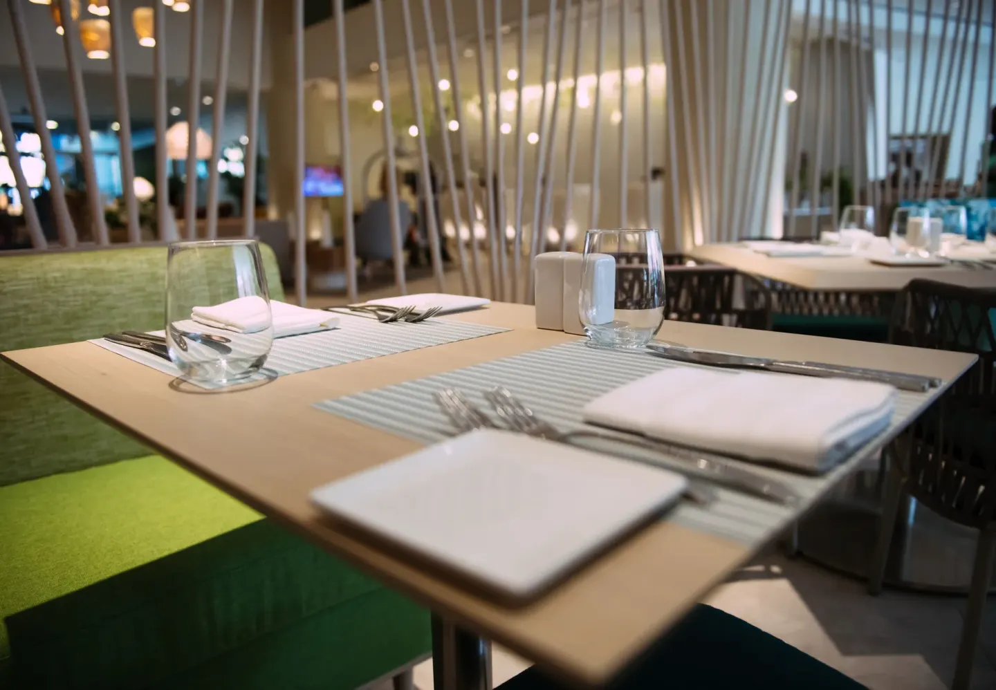 Set dining table inside a restaurant at Renaissance Wind Creek Curacao Resort.