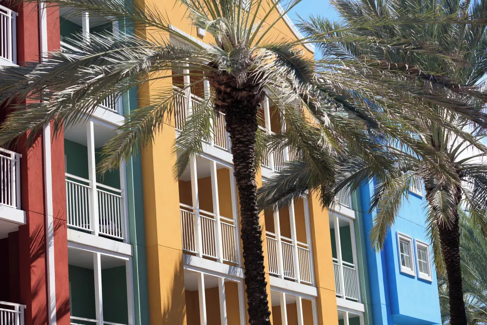 Executive Suite balcony exterior at Renaissance Wind Creek Curacao Resort framed by palm trees.