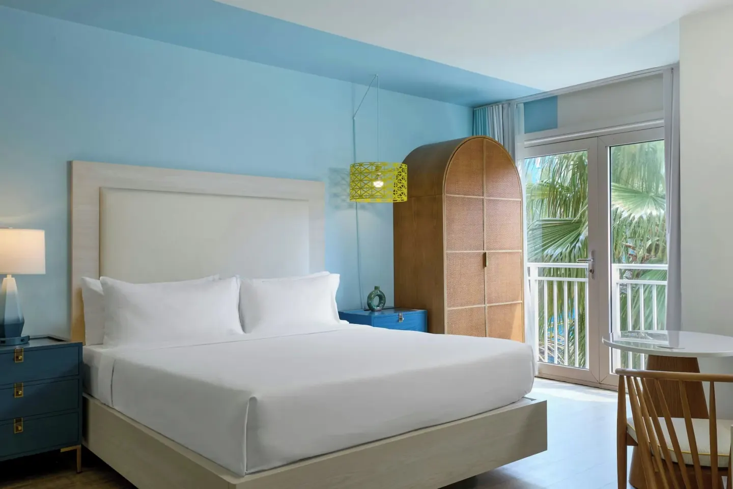Executive suite king bedroom with balcony doors at Renaissance Wind Creek Curacao Resort.