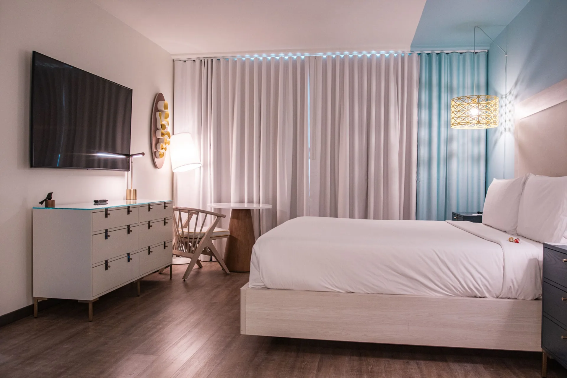 Executive suite bedroom with king bed and wall-mounted TV at Renaissance Wind Creek Curacao Resort.