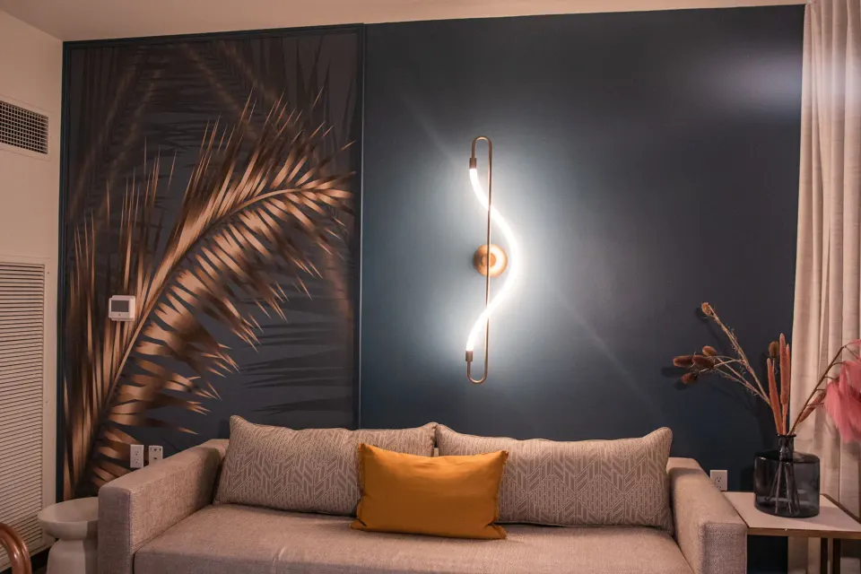Executive suite sitting area with sofa and palm mural at Renaissance Wind Creek Curacao Resort.