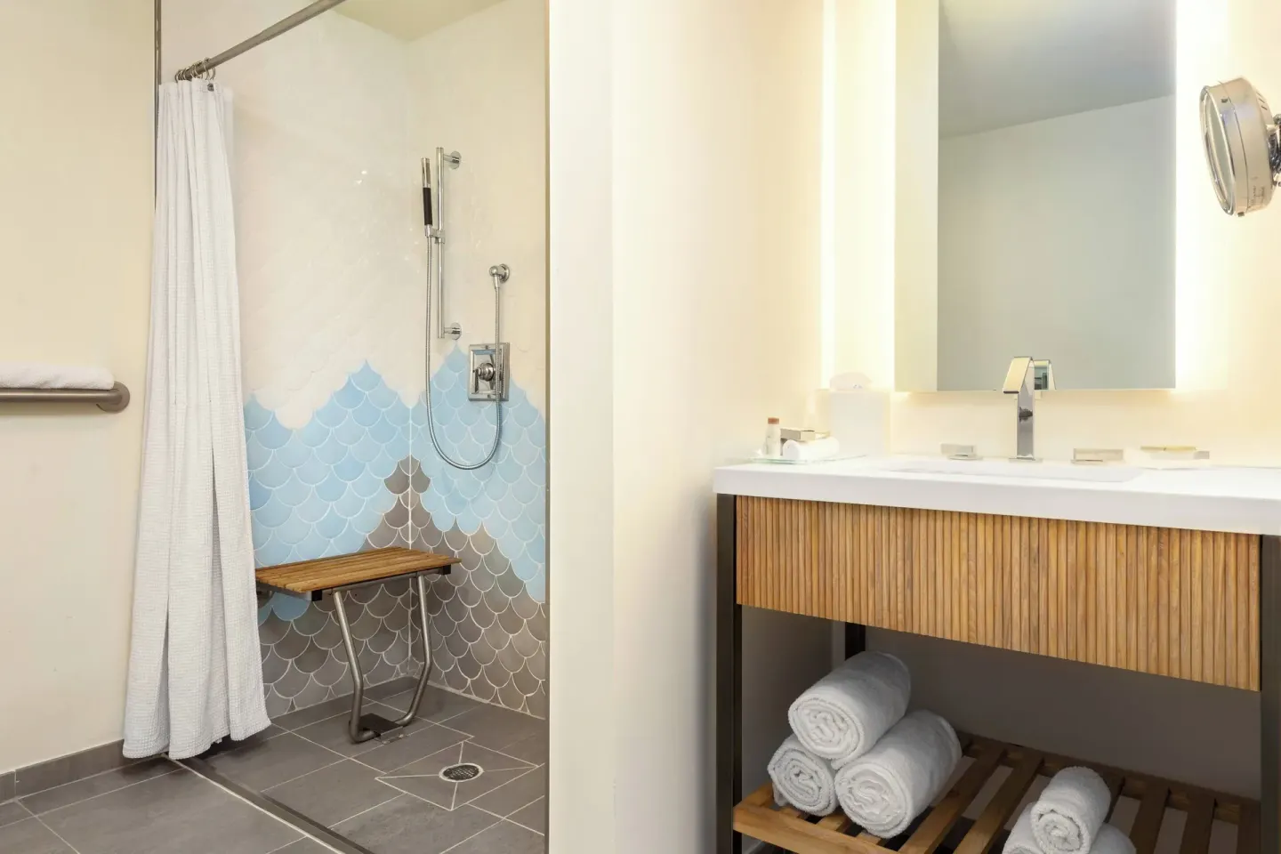 Accessible guest bathroom with roll-in shower at Renaissance Wind Creek Curacao Resort.