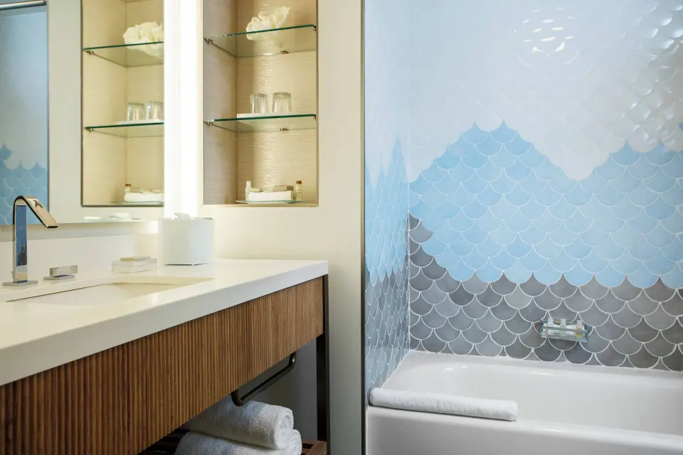 Guest bathroom with vanity and bathtub at Renaissance Wind Creek Curacao Resort.