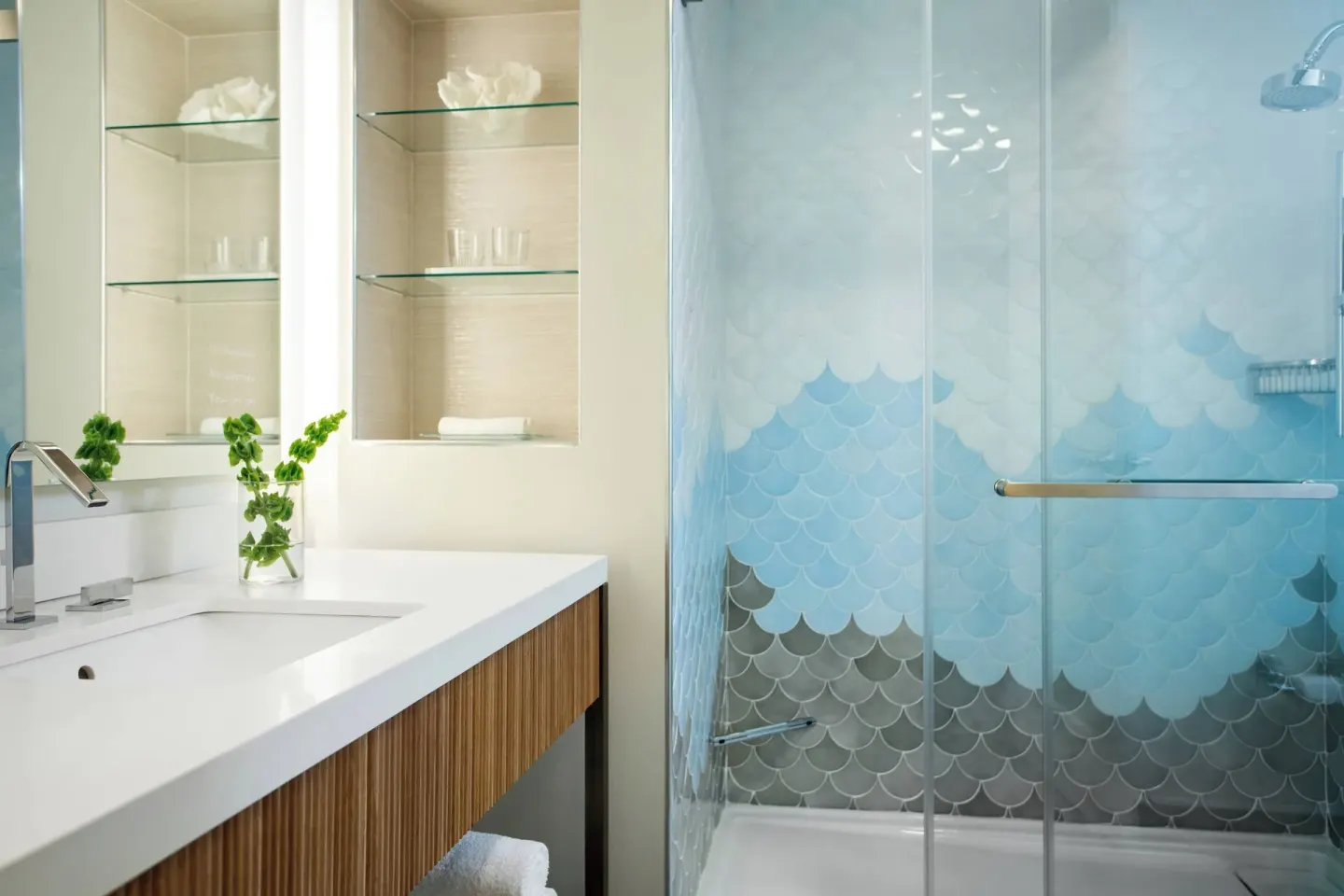 Guest bathroom shower and vanity at Renaissance Wind Creek Curacao Resort.