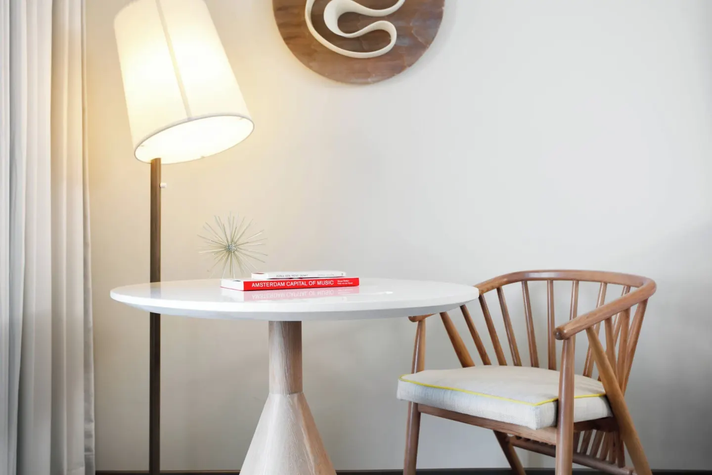 Guest room table, chair and floor lamp at Renaissance Wind Creek Curacao Resort.