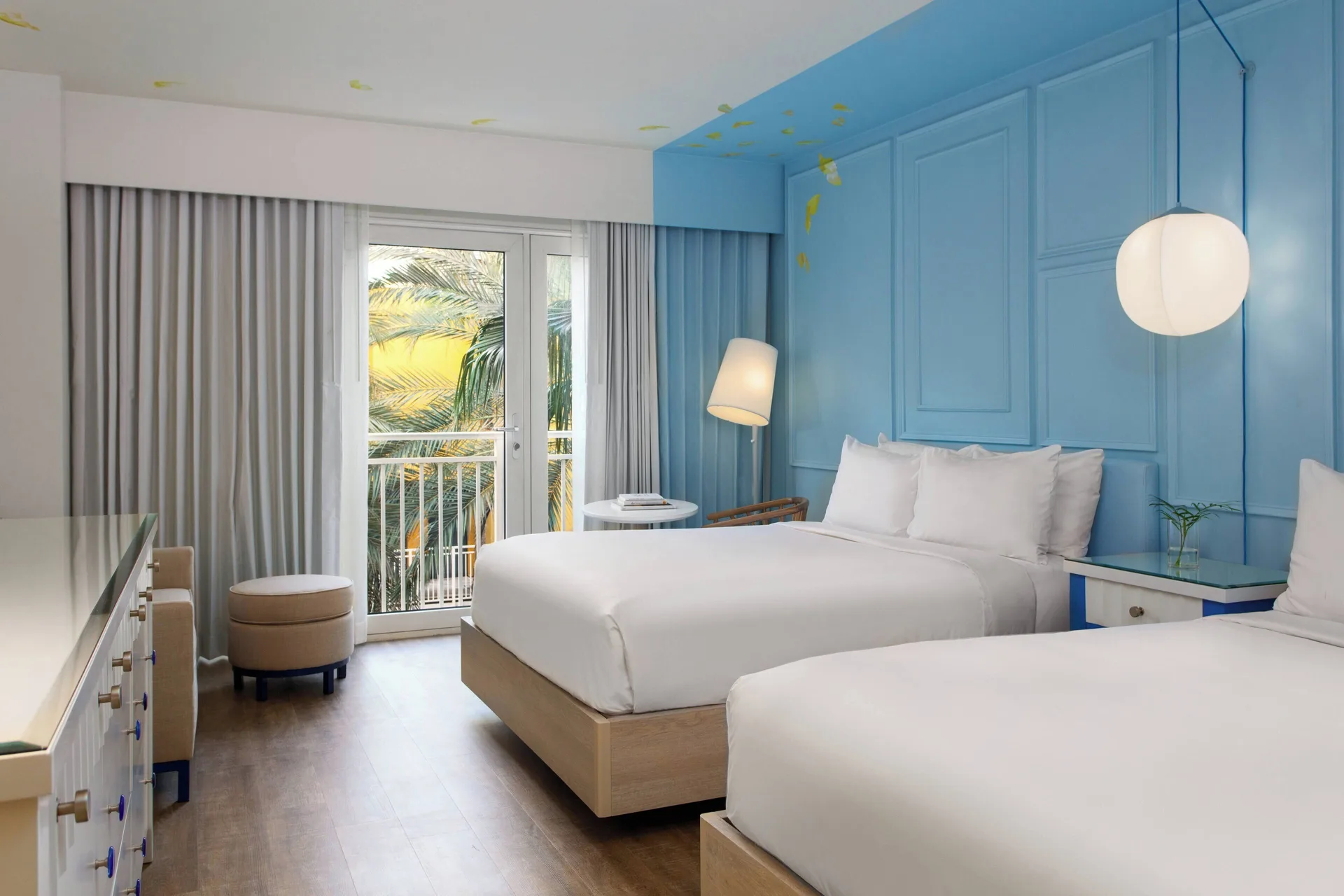Two-bed resort view room with blue wall at Renaissance Wind Creek Curacao Resort.