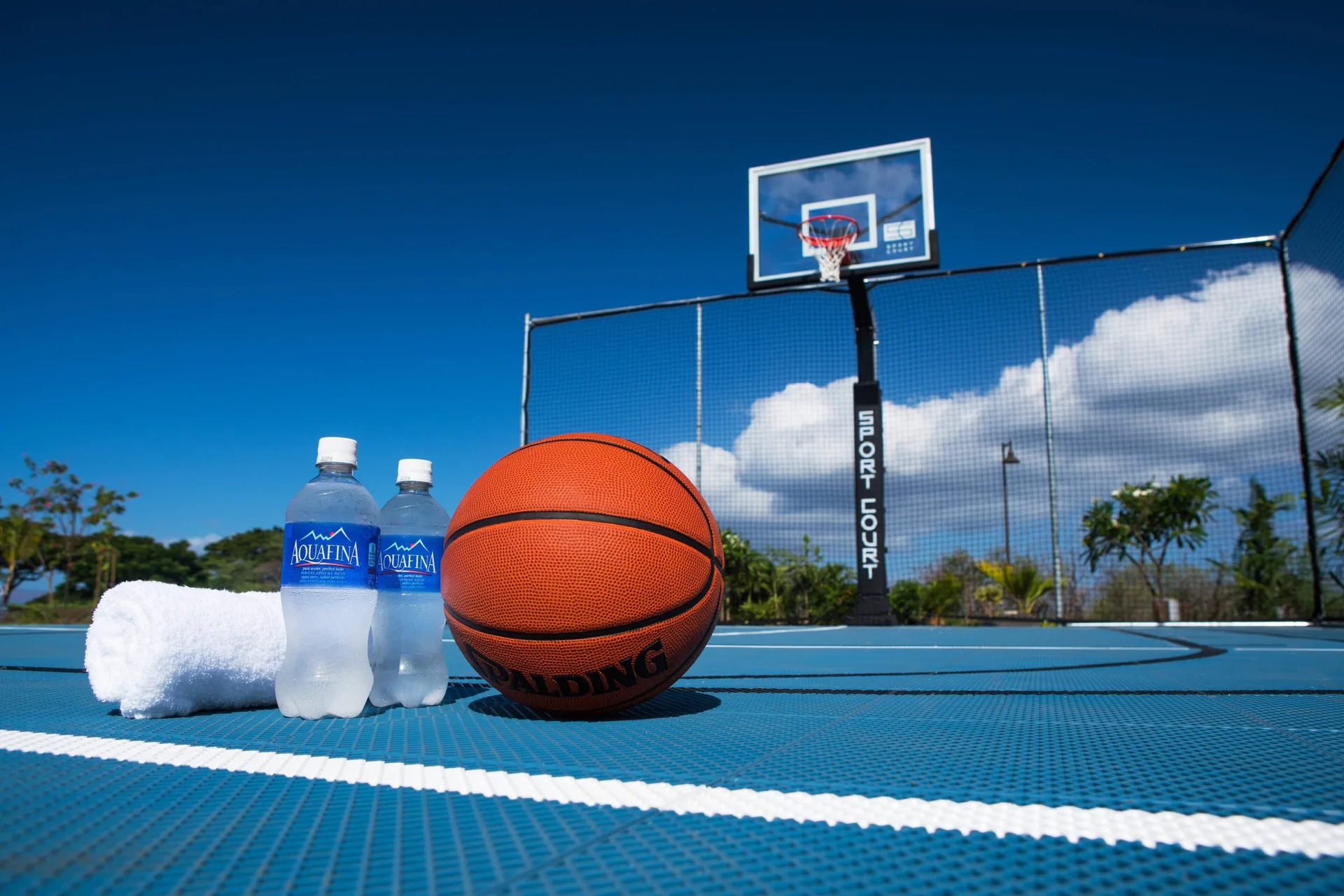 Basketball court with ball, towels and water at Residence Inn Maui Wailea.