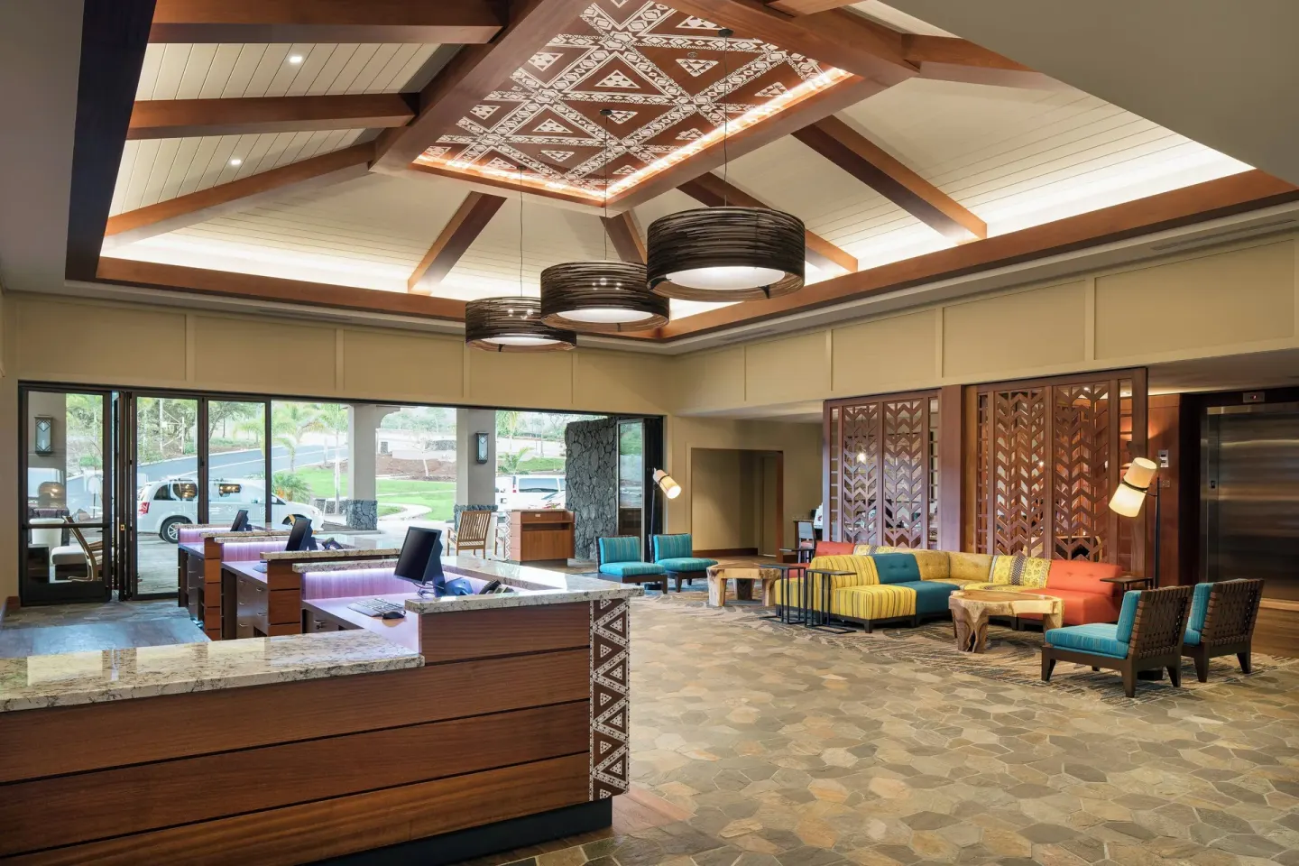 Lobby check-in desks and colorful seating area at Residence Inn Maui Wailea.